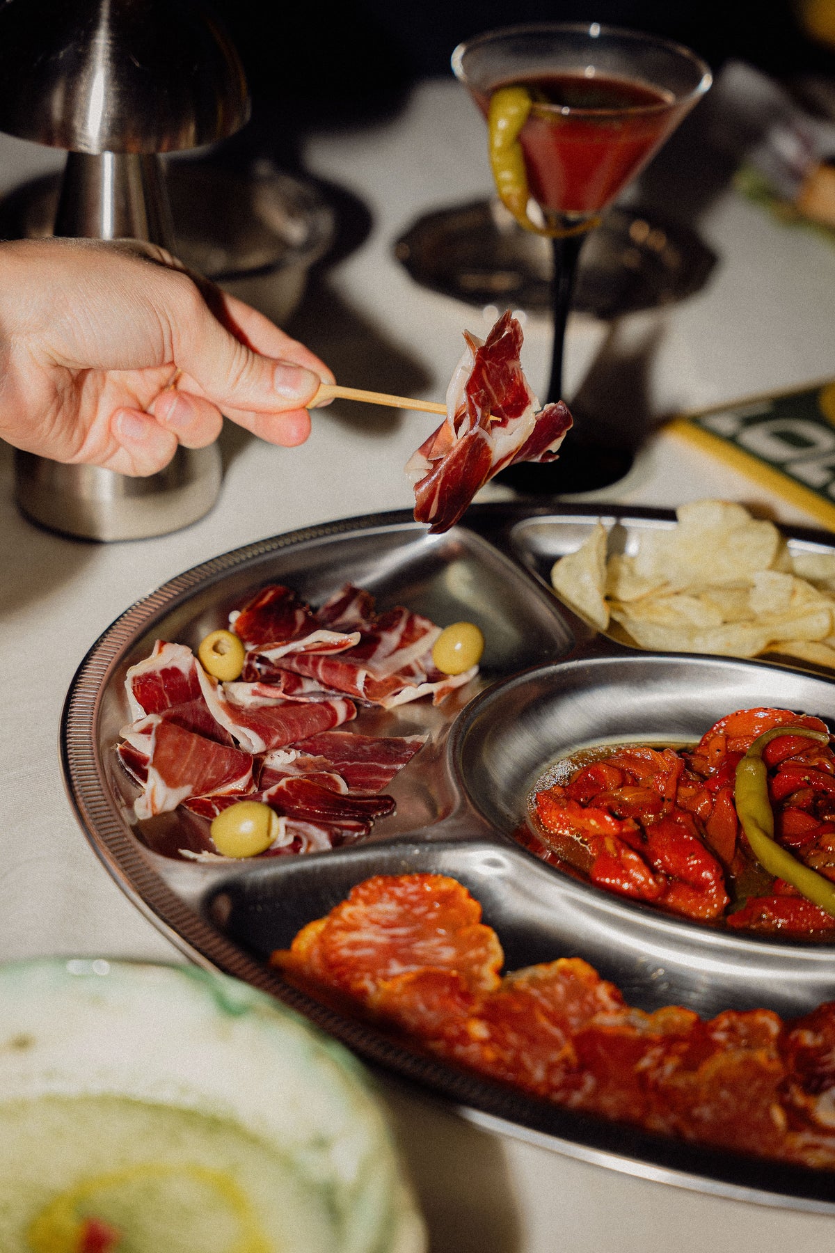 Plate of Iberico ham and charcuterie at an aperitivo